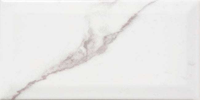 Bevel Metro Carrara 10x20 gloss wall tile from The Tile Collection, showcasing white marble-look ceramic tile with beveled edges.